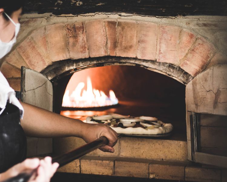 Round table pizza kitchen — handcrafting fresh pizza dough